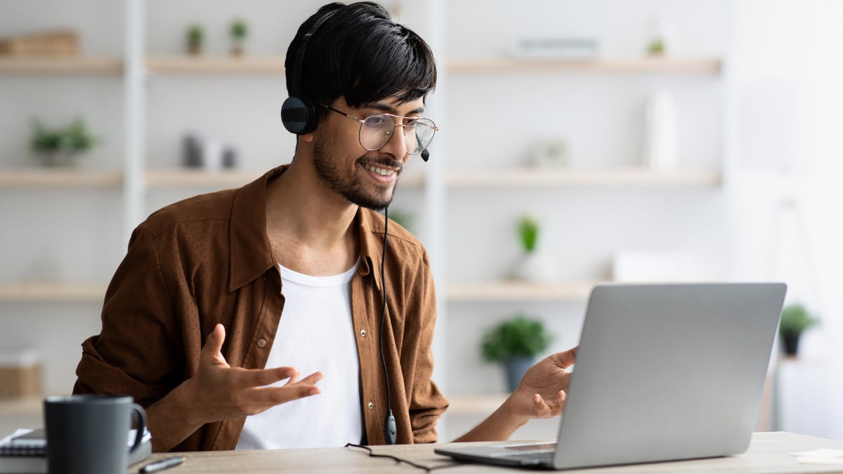 Male college student taking part in an online college class