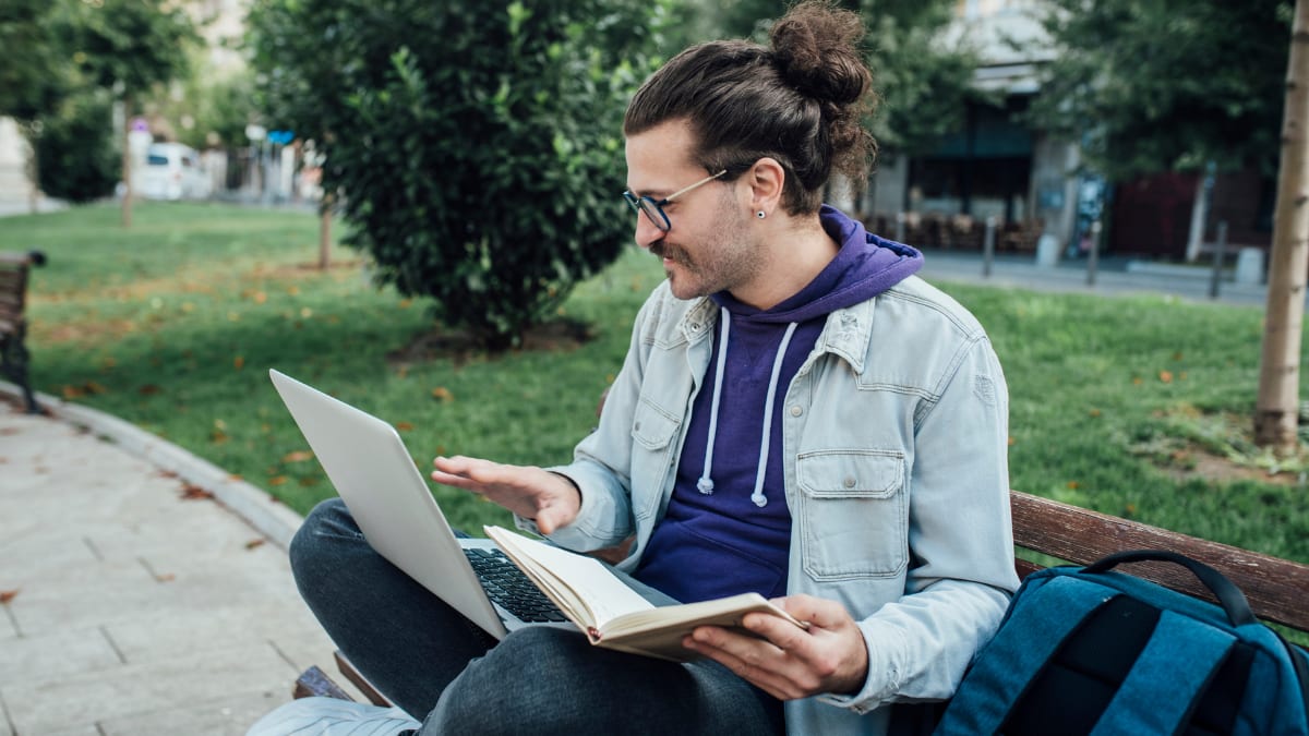 Male college student participating in an online college class