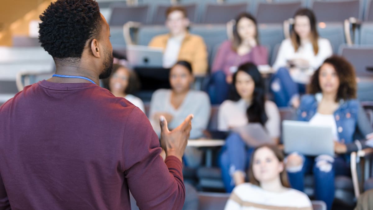 Male college professor standing in front of a class