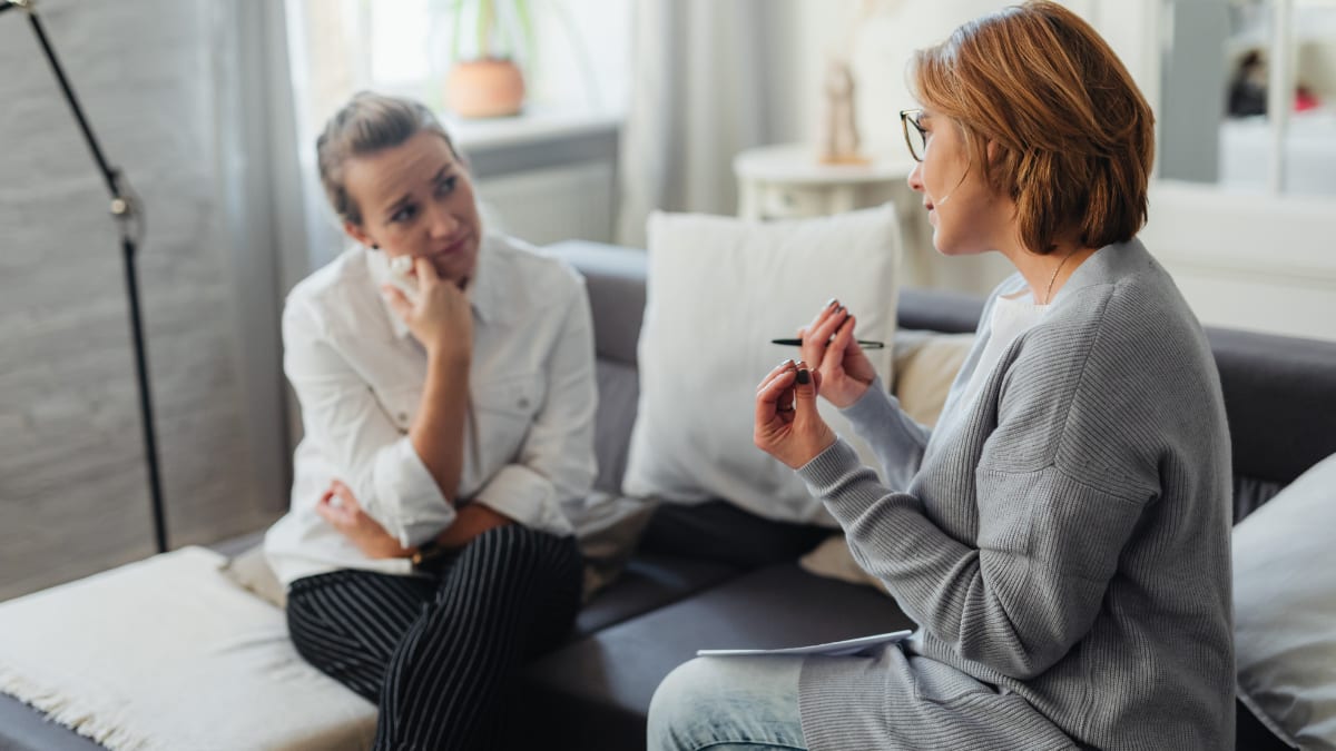 female psychologist talking with a distraught client