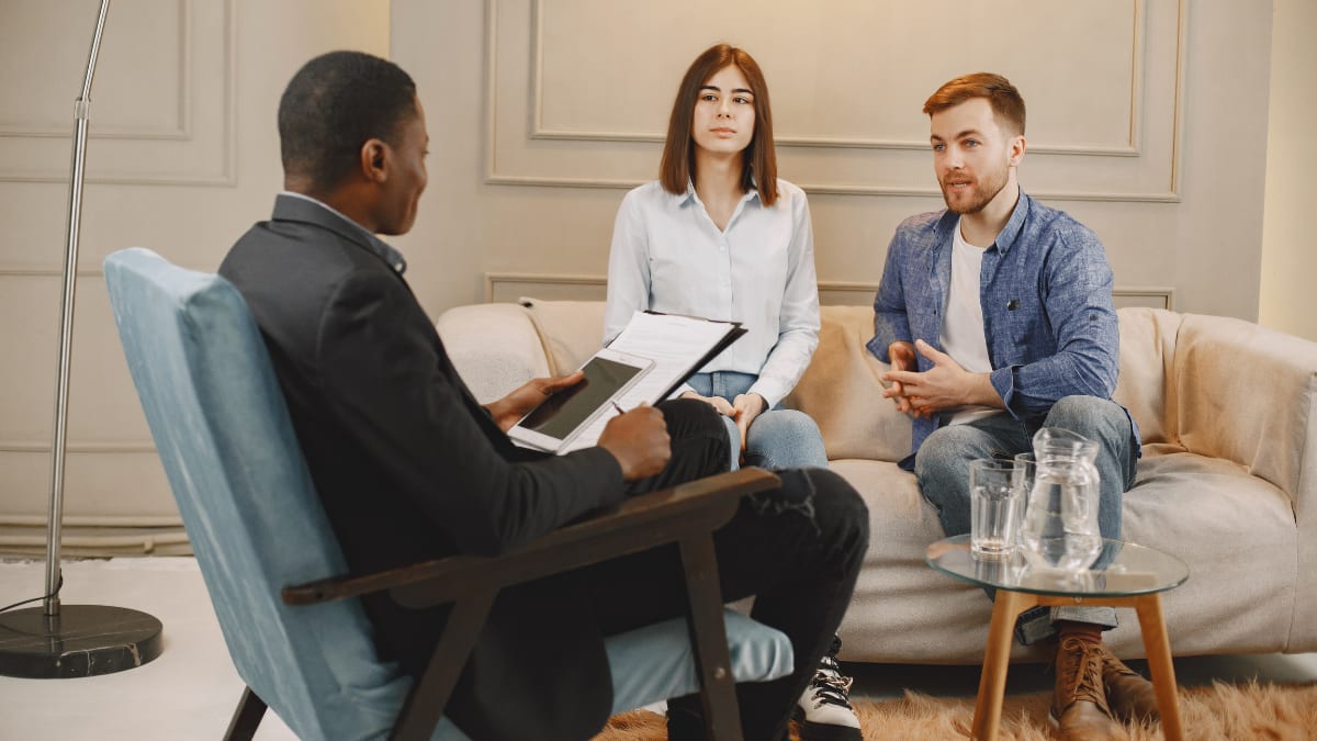 male psychologist talking with a married couple