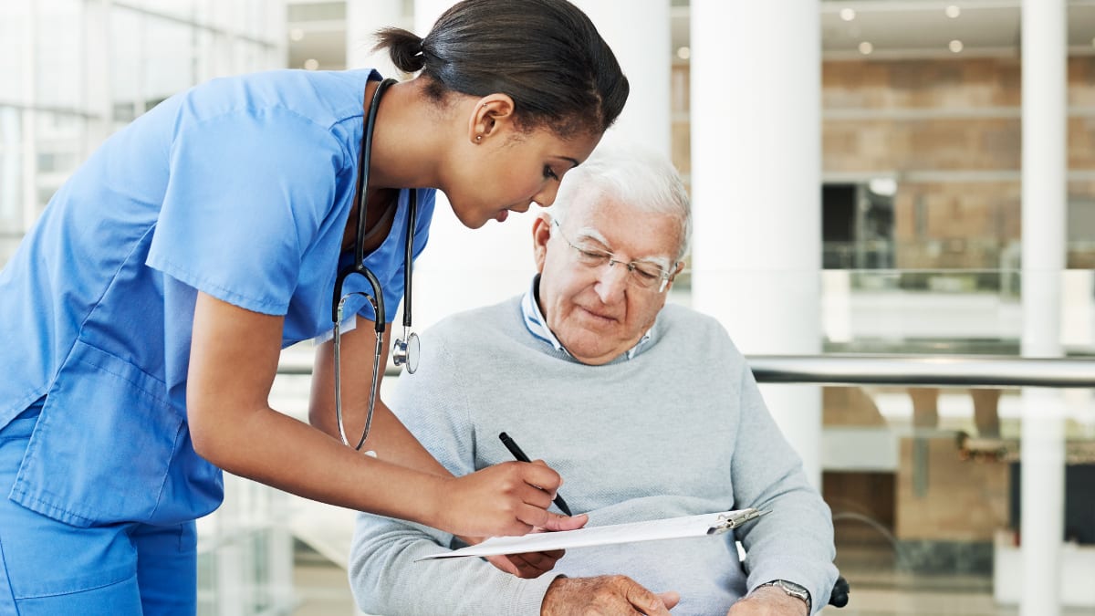 Female nurse talking to a female patient