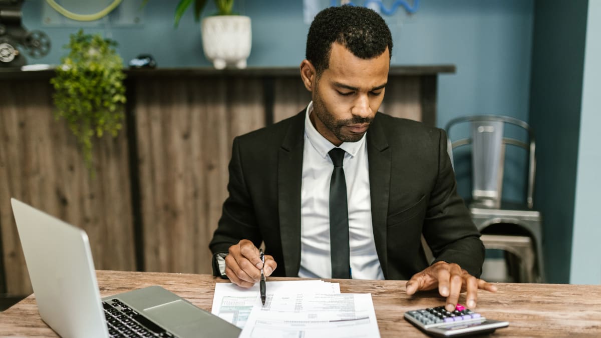 accountant reviewing accounts with a calculator