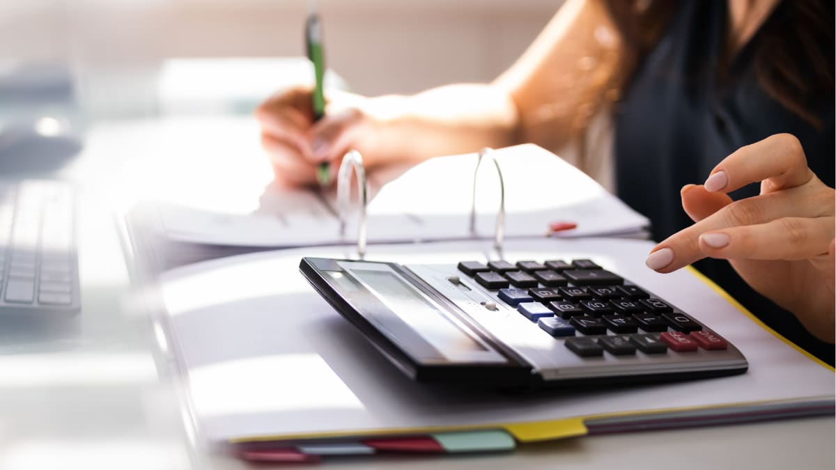 close-up photo of accountant using a calculator