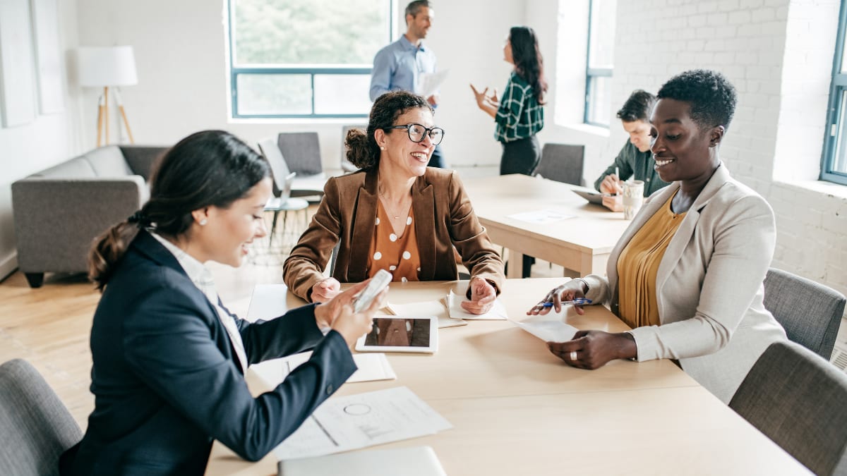 team of accountants sitting at a conference table reviewing financial information