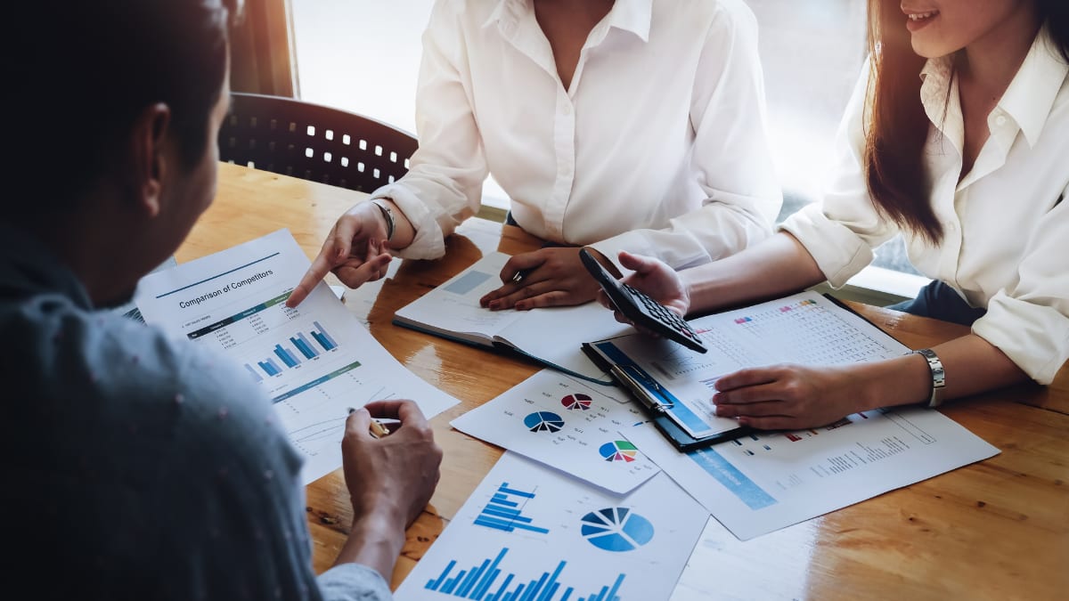 team of accountants performing a cost-benefit analysis