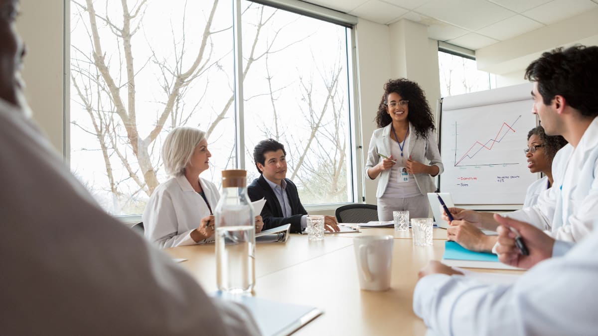 healthcare administrator discussing policies with hospital staff