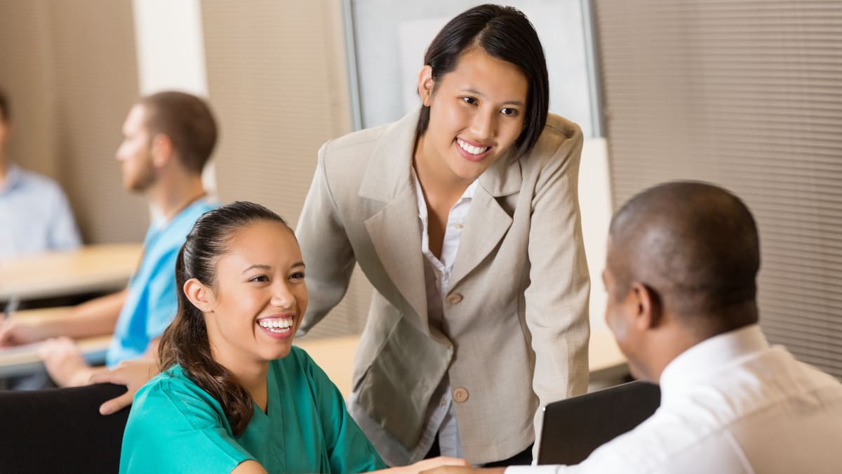 healthcare administrator speaks to hospital staff