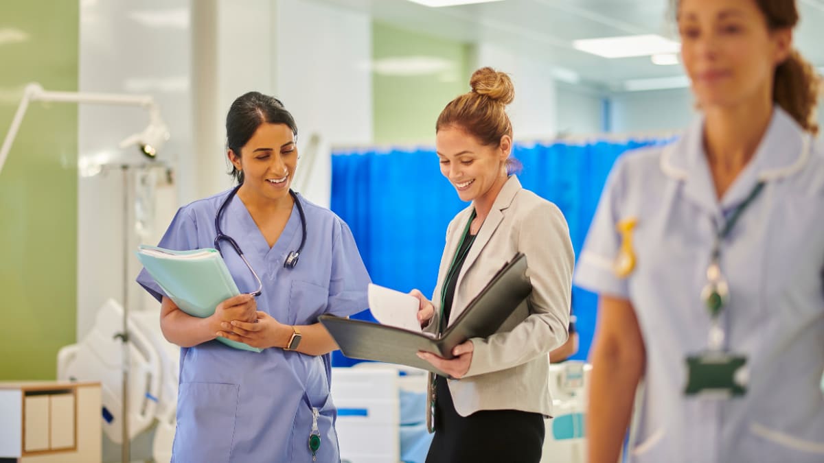 healthcare administrator speaks with a doctor