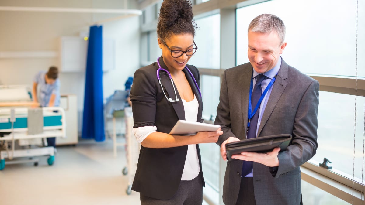 hospital administrator speaks with a nurse practitioner