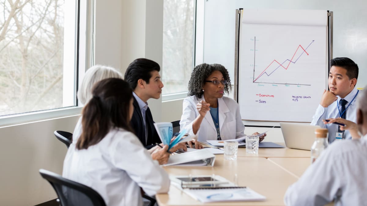 hospital administration discusses hospital financials with a group of doctors