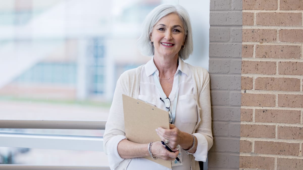 hospital administrator standing near a wall