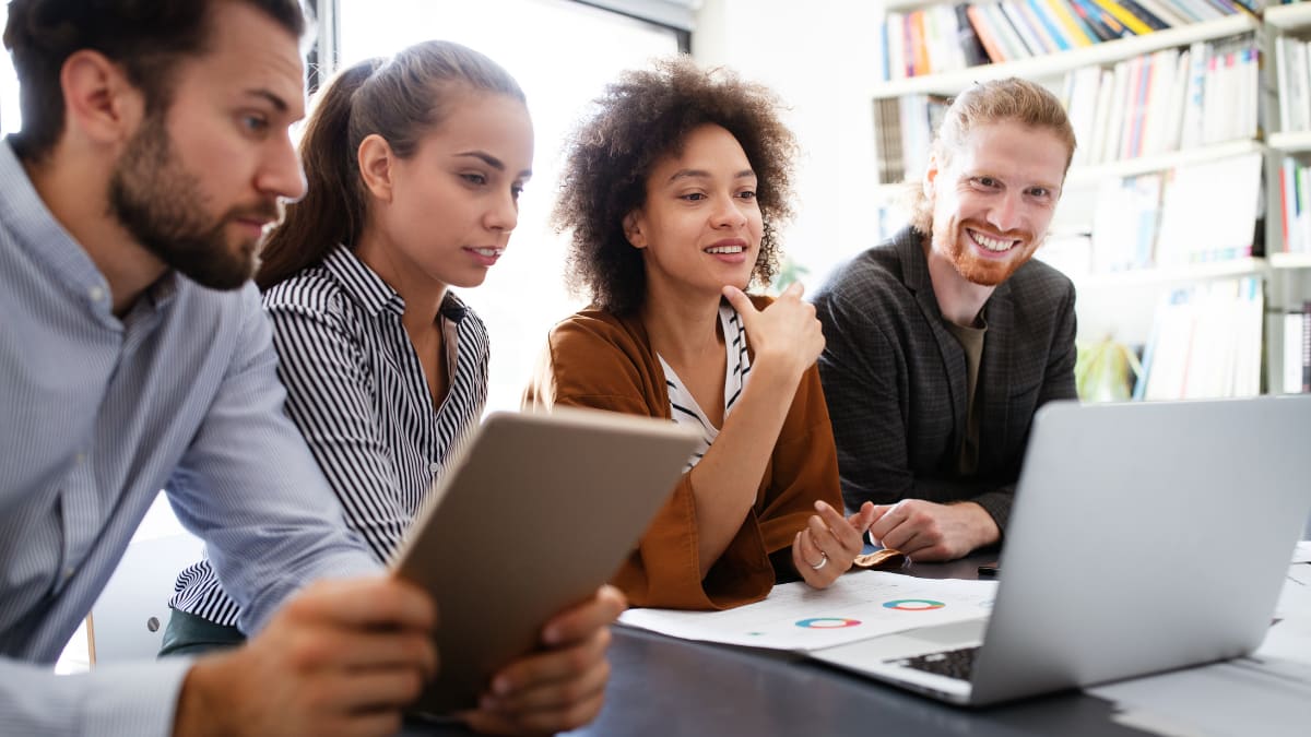 information technology team working together at a computer