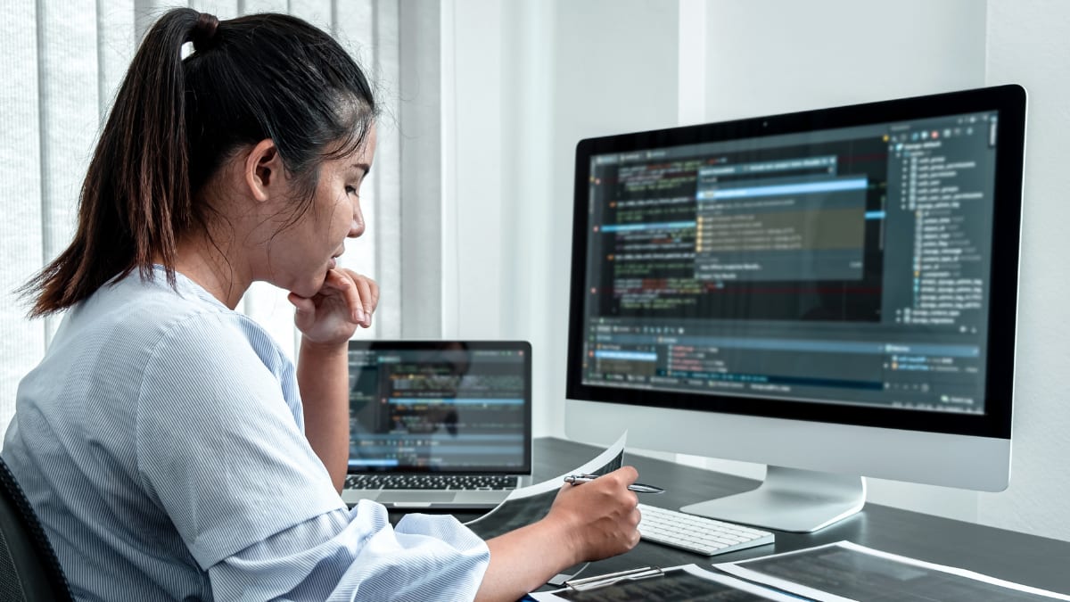software programmer writing code in an IT office
