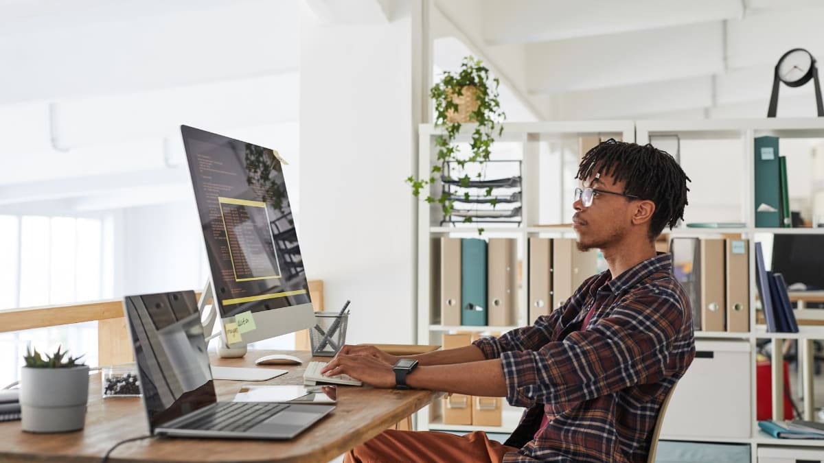 computer specialist sitting at a desk