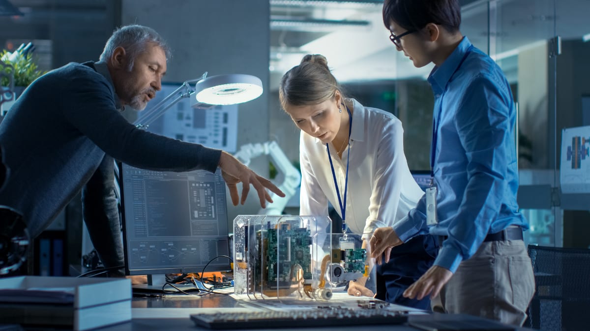 team of computer engineers looking at printed circuit boards