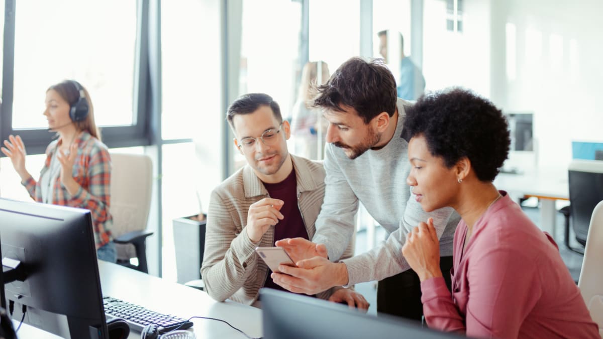 cybersecurity professionals meeting together in an office