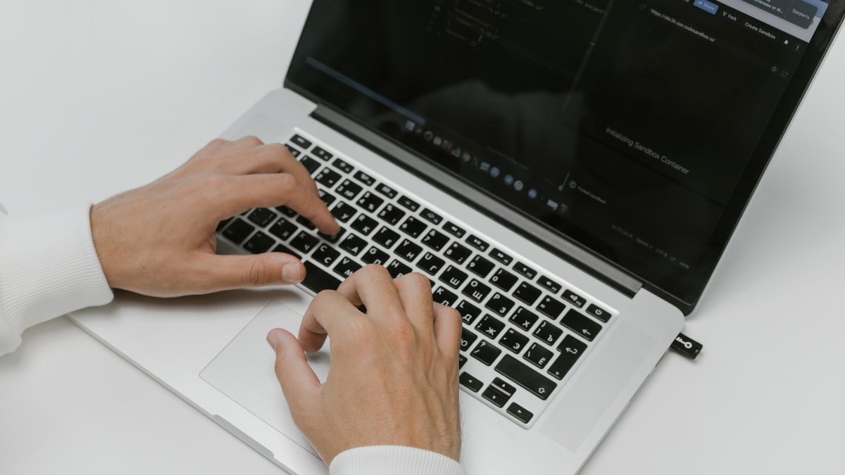 close up of hands typing on a computer