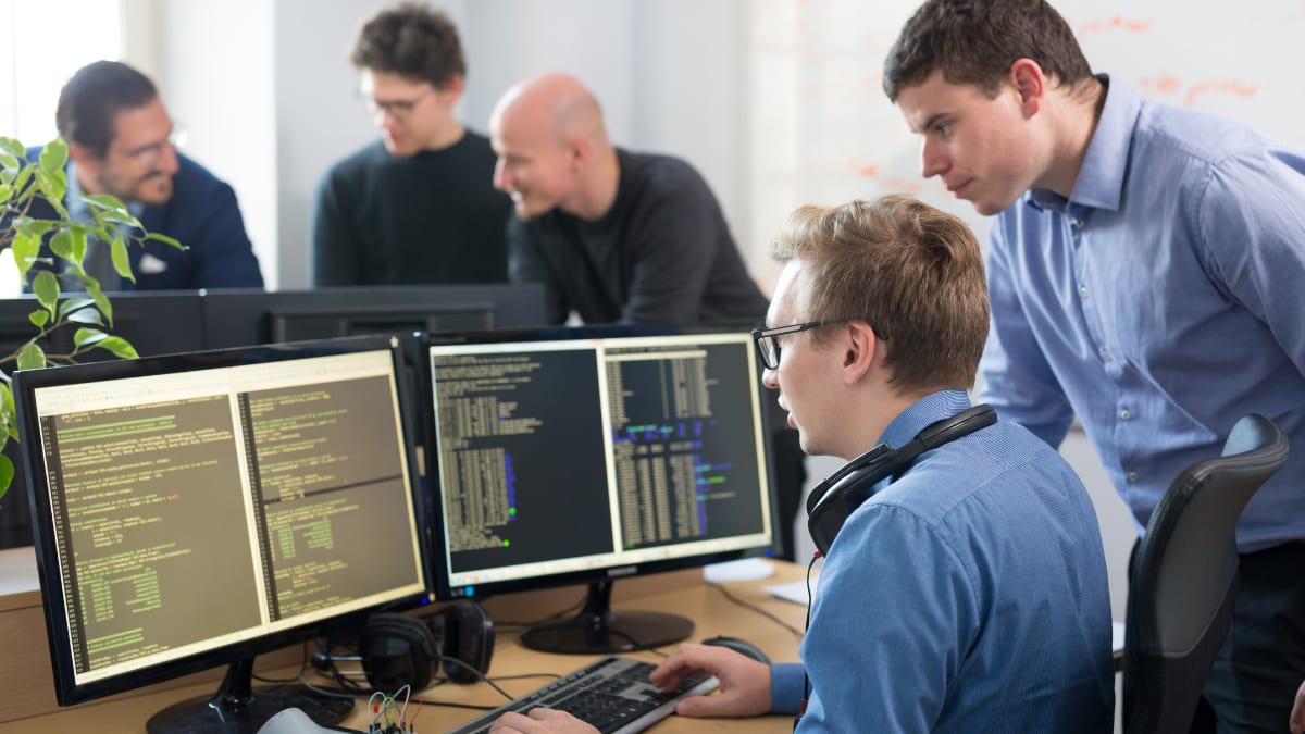 cyber security professionals working together in front of a desk