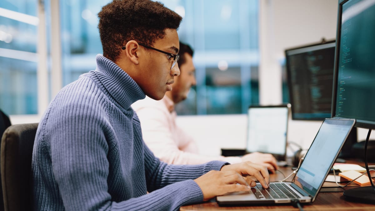 cyber security doctorate student working on a computer