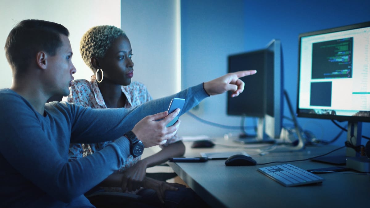 two IT professionals working on cyber security defense plan