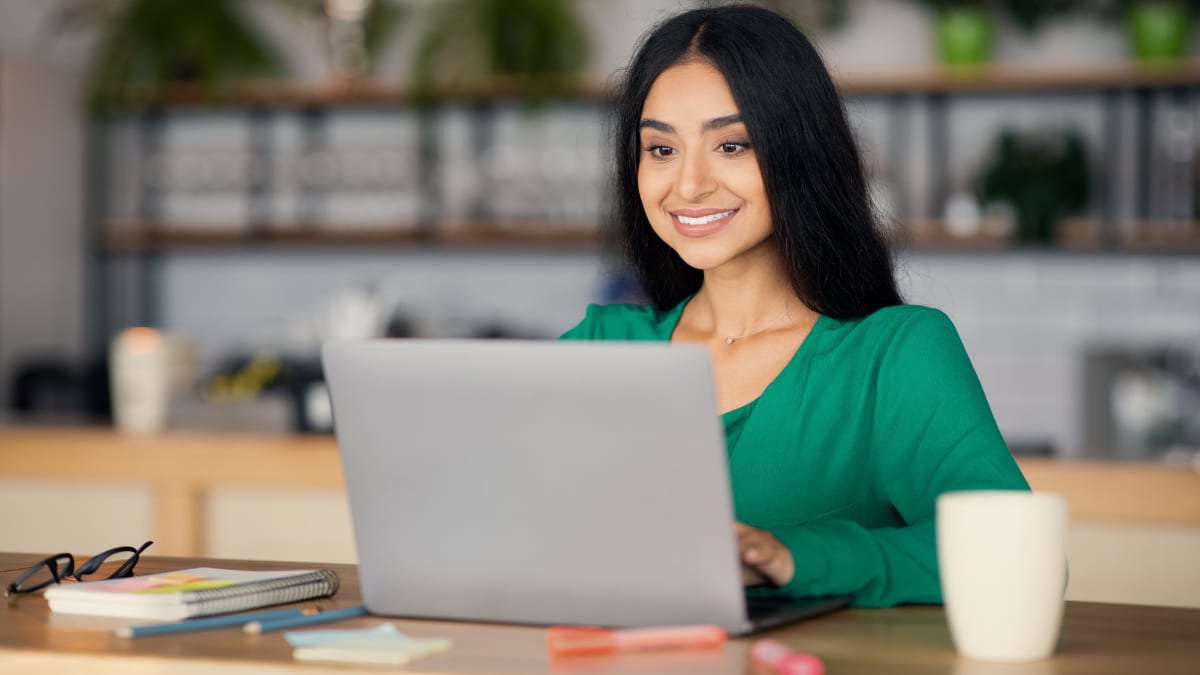 online student working at home in her kitchen