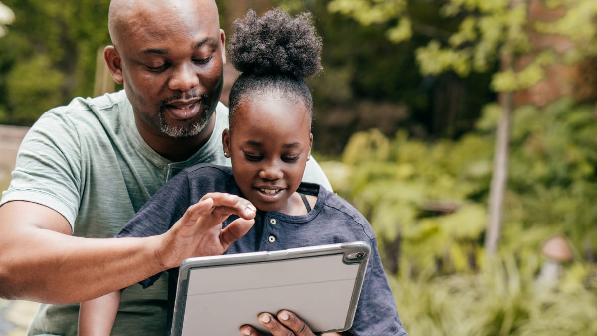 online college student sitting with his child