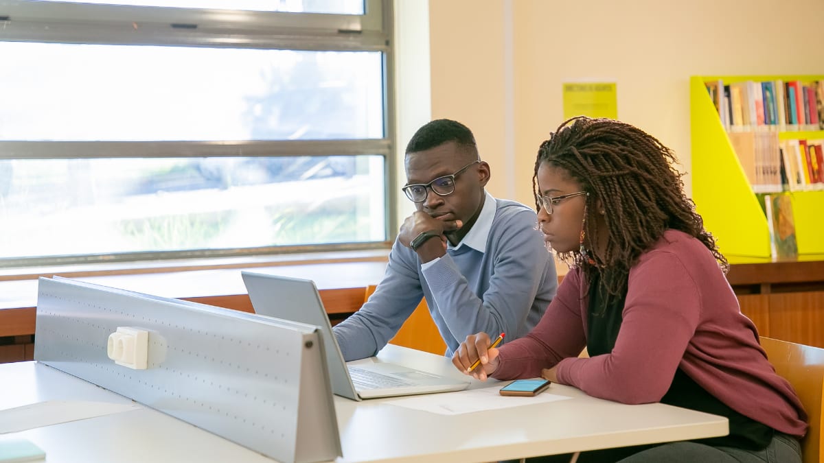 two college students working in a computer lab at an HBCU school