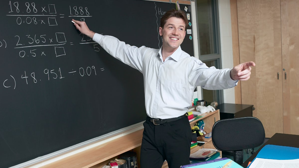 math teacher working on math problems with his students