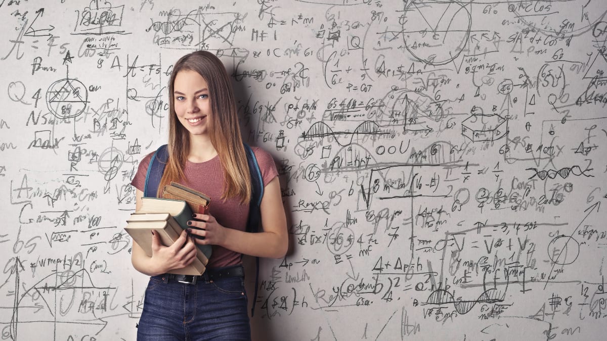 physics student standing in front of a white board
