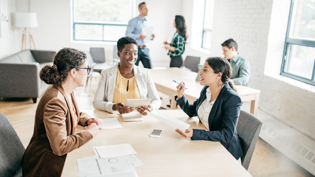 business people sitting around a table having a meeting