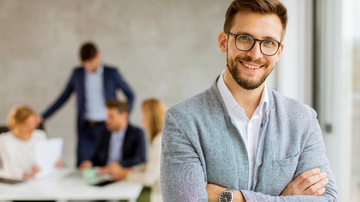 business person standing in front a team of people