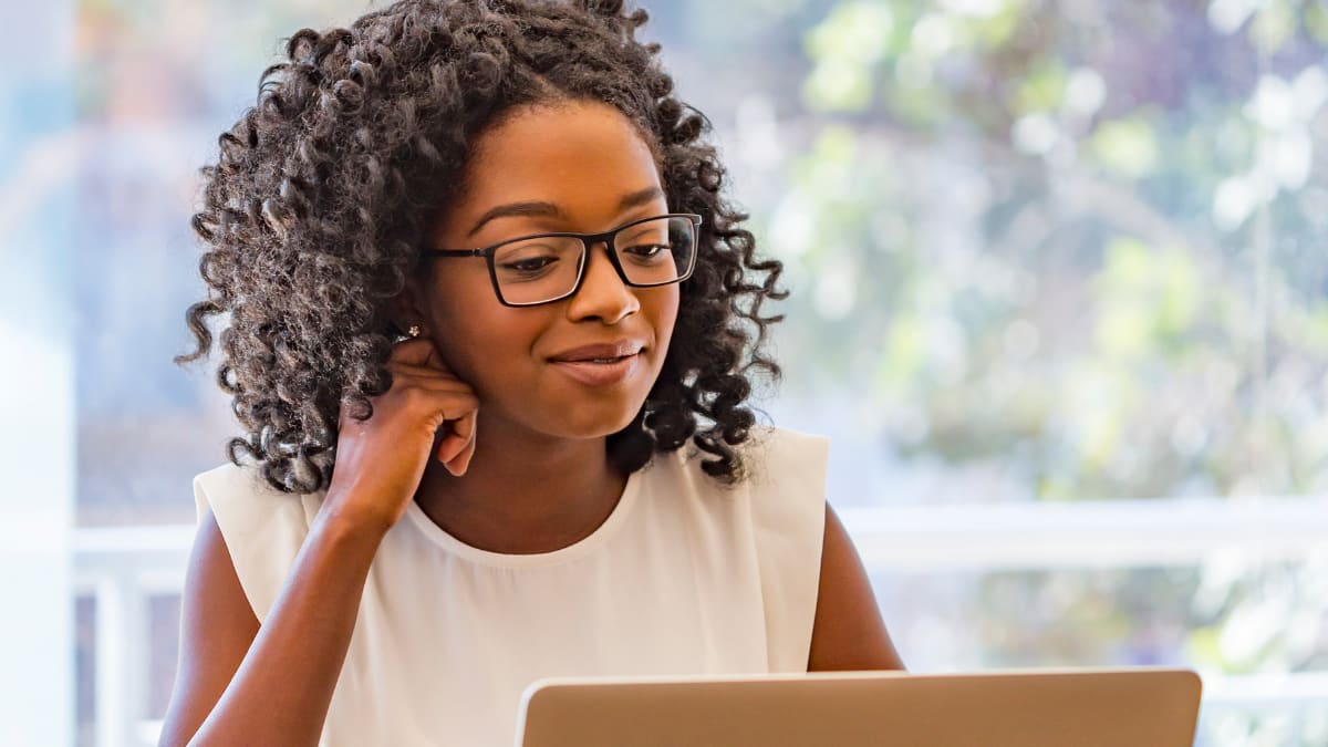 young business professional working on a laptop