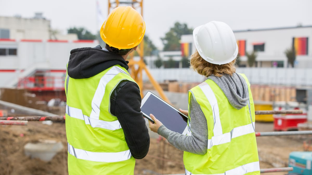 two construction managers look over a construction project