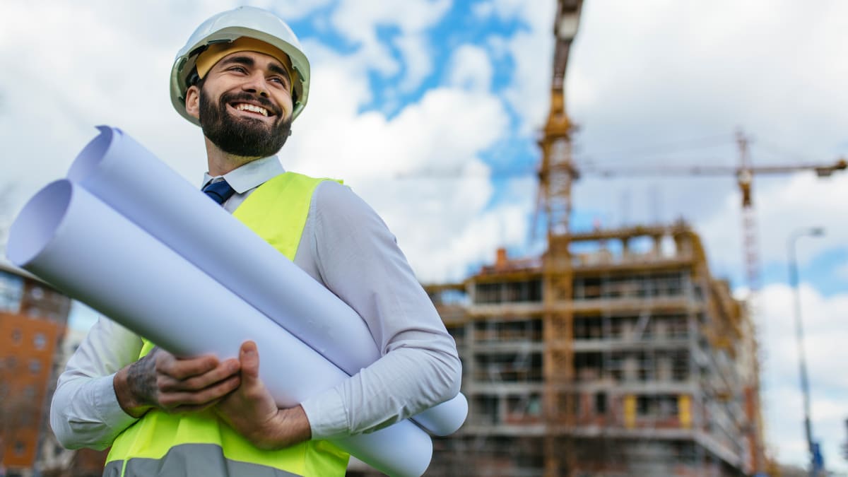 construction manager holding a set of building plans