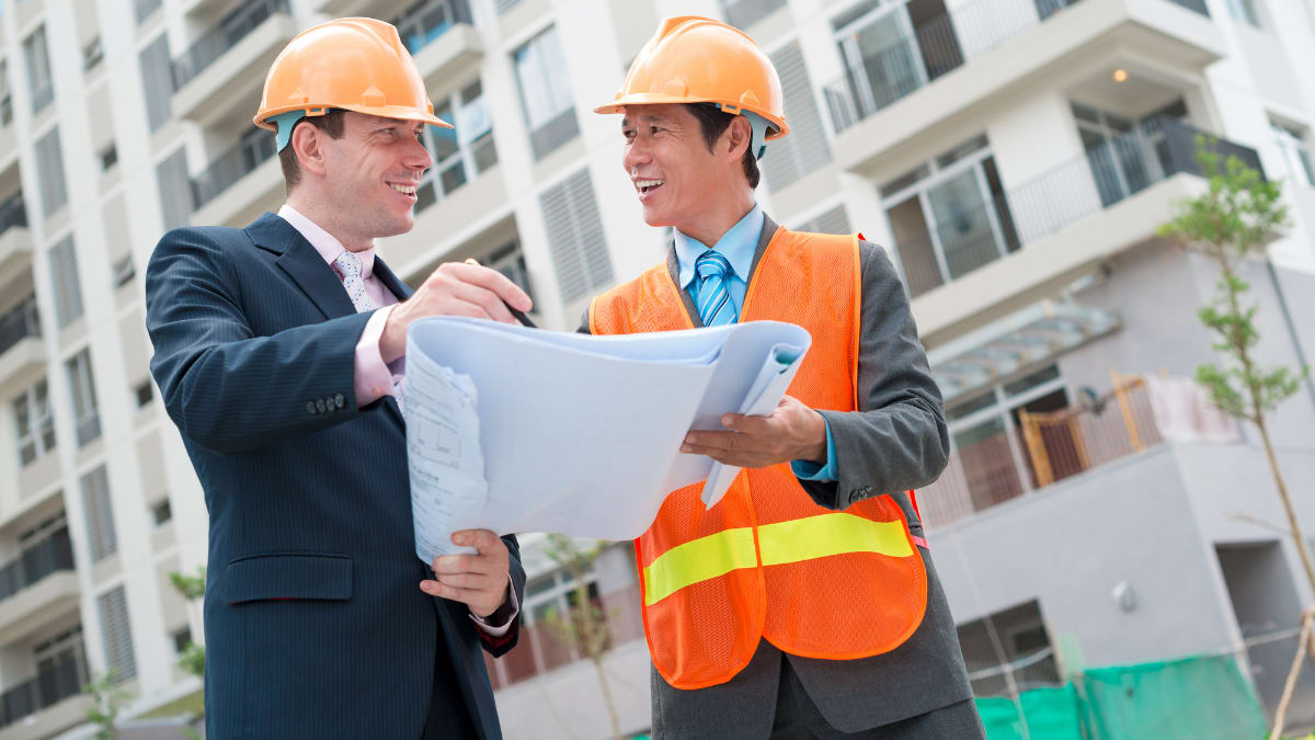 construction manager looking at building plans with an investor