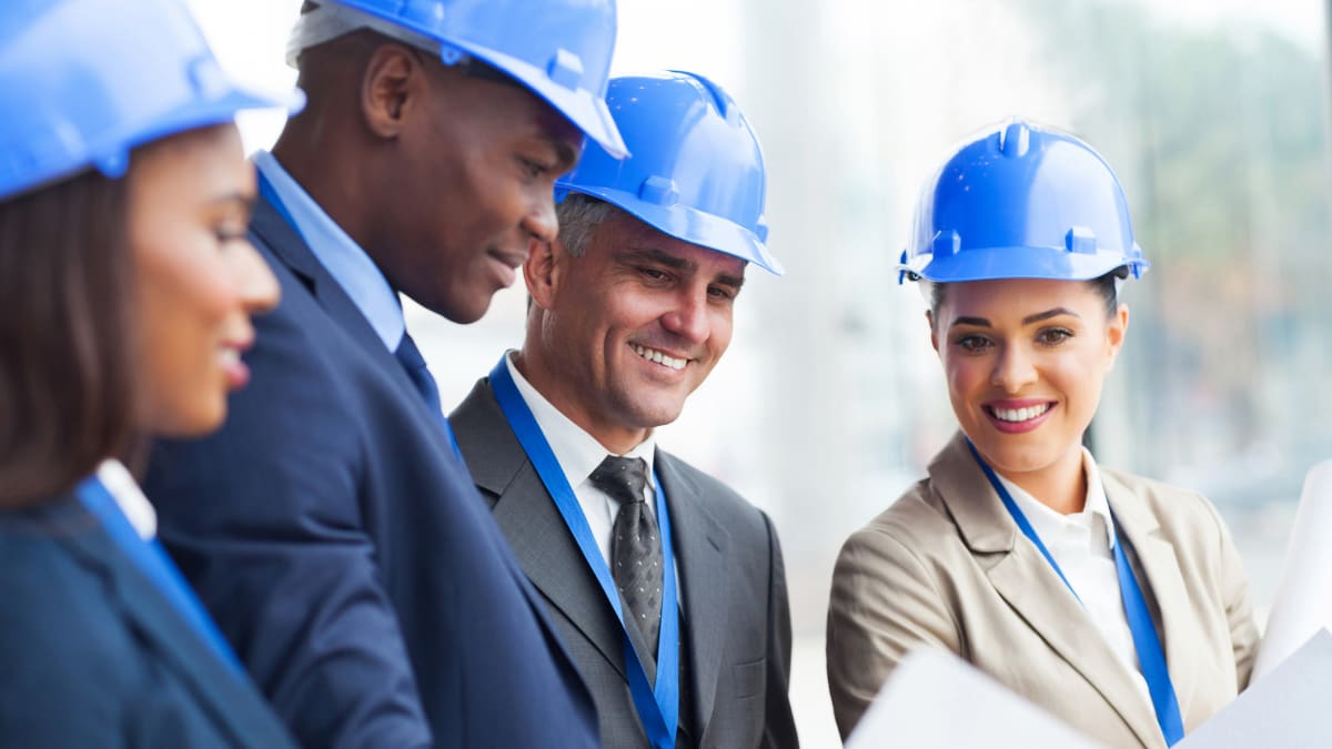 a group of investors look over building plans for a construction project