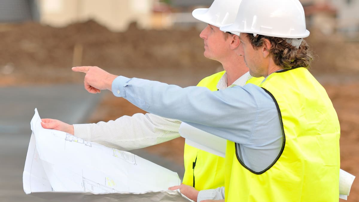 two construction managers discuss a building project