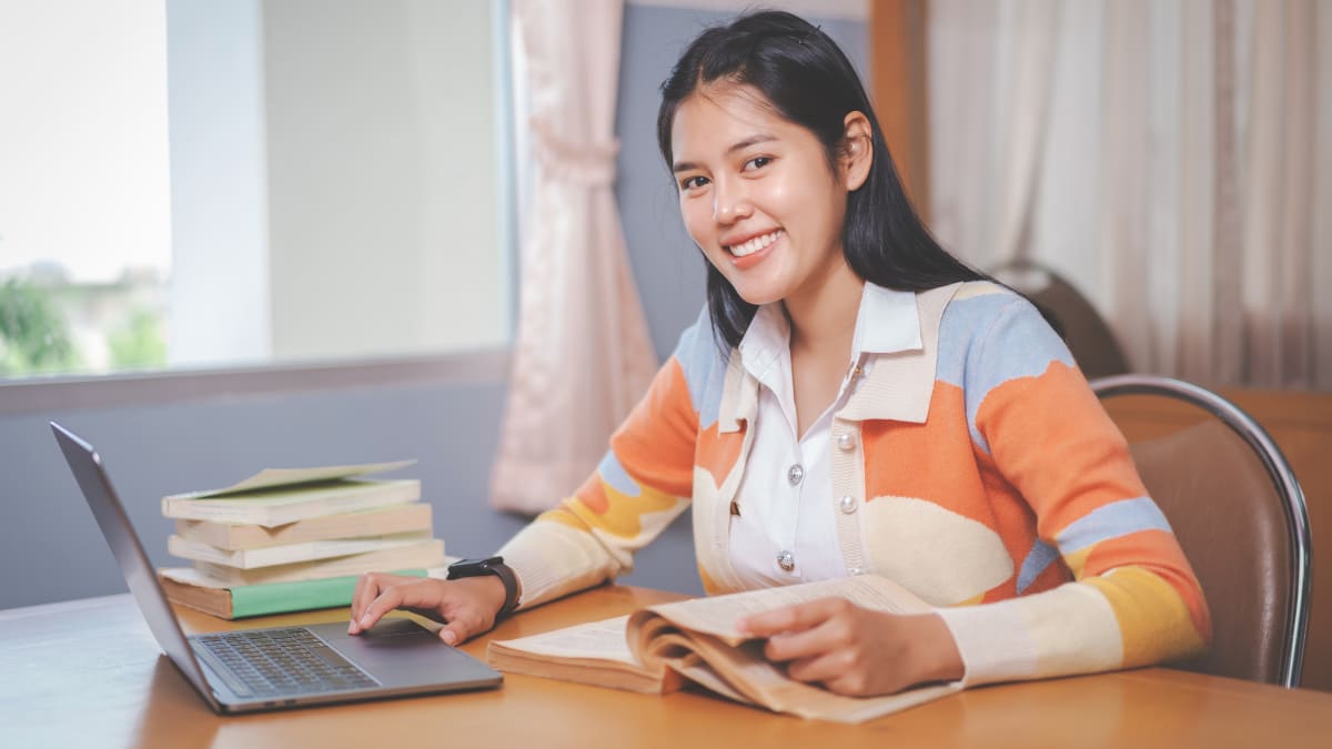 online college student sitting at a desk working on online coursework