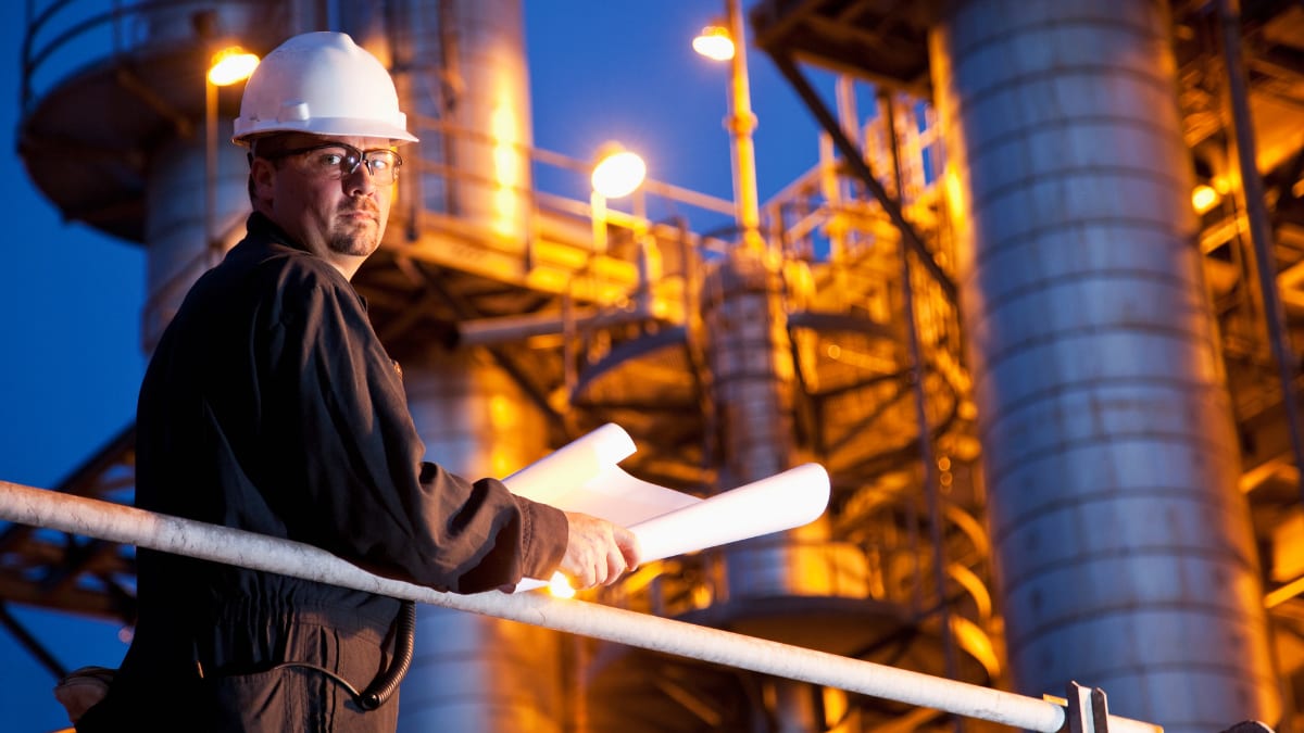 chemical engineer standing outside a chemical plant