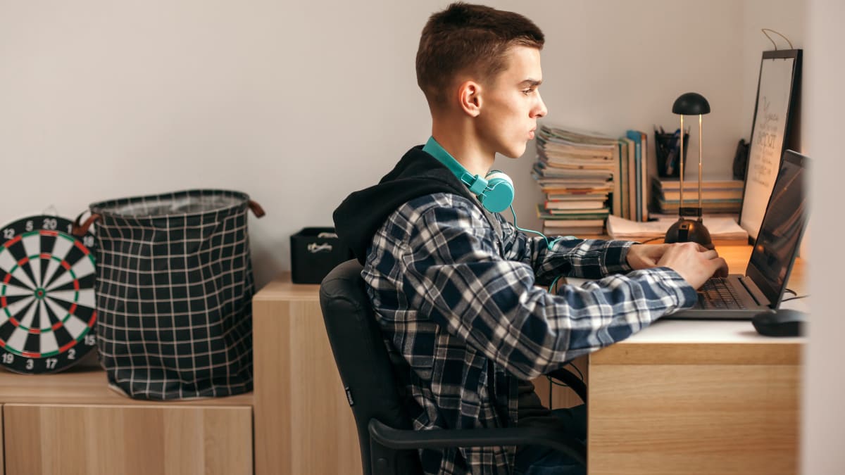 online student sitting at a desk doing online coursework