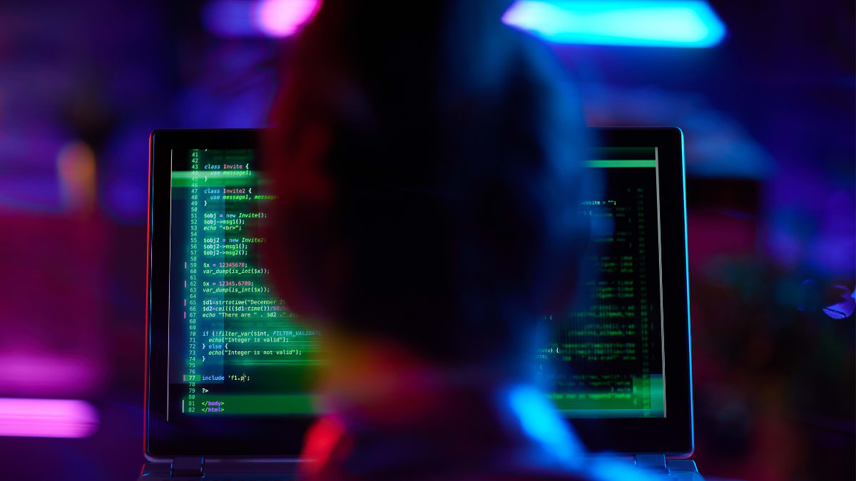 cybersecurity professional sitting in front of a laptop