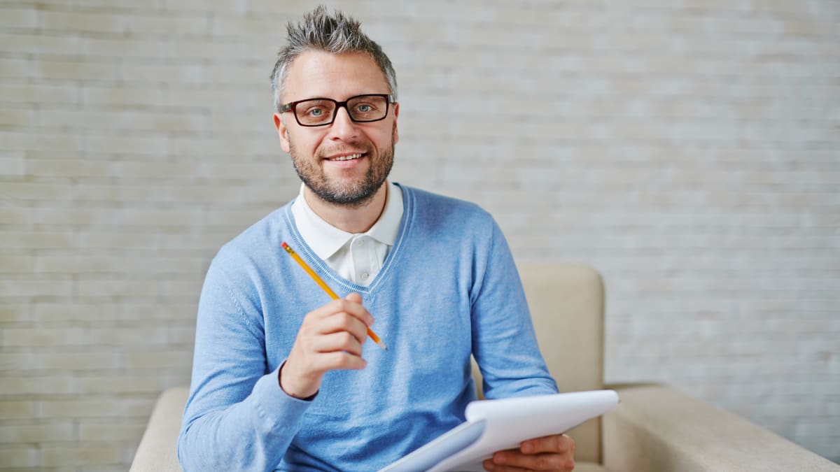 psychologist holding a notepad and pencil
