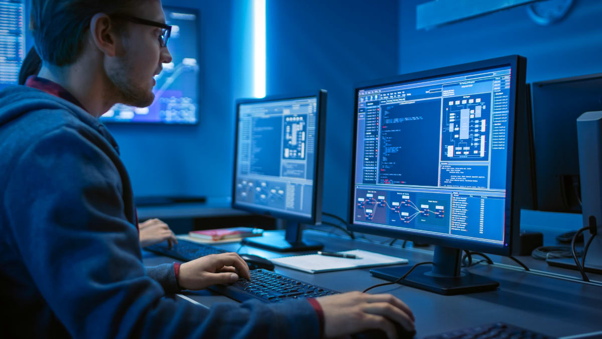 IT programmer working on a desktop computer