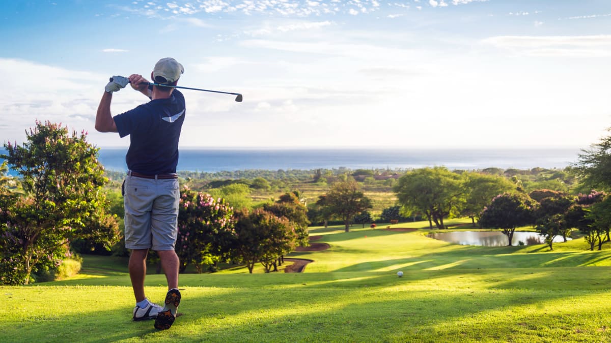 golfer taking a swing on a golf course