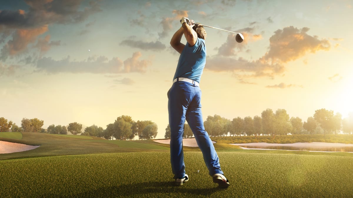 golfer taking a swing on a golf course