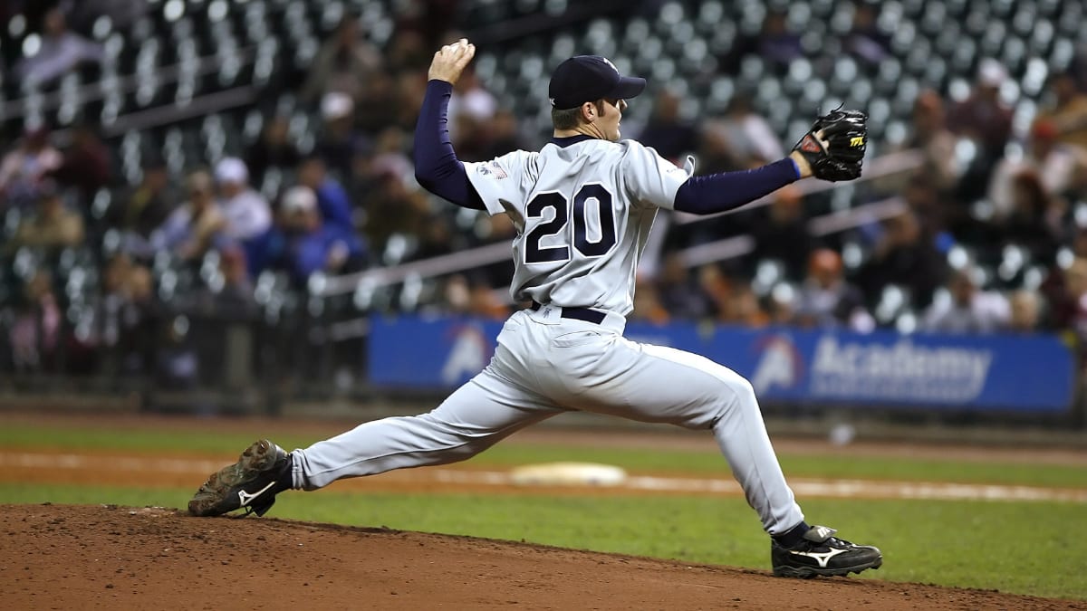 pitcher throwing a baseball from the pitcher's mound