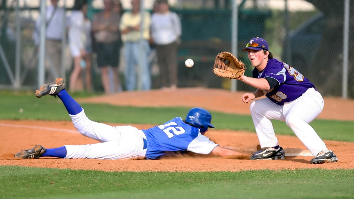 baseball player sliding into home base