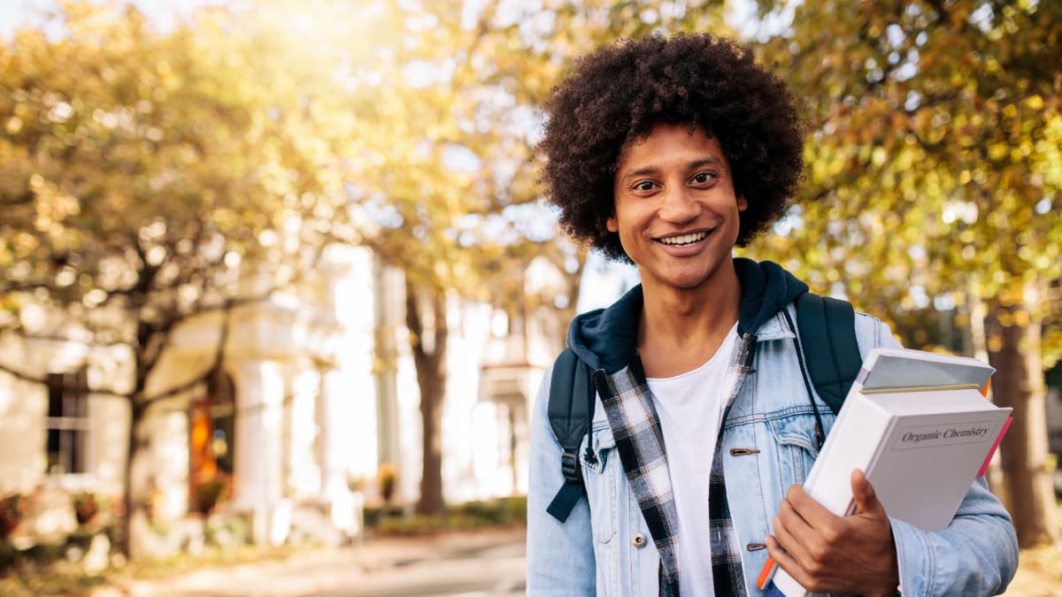 graduate student walking outside on campus
