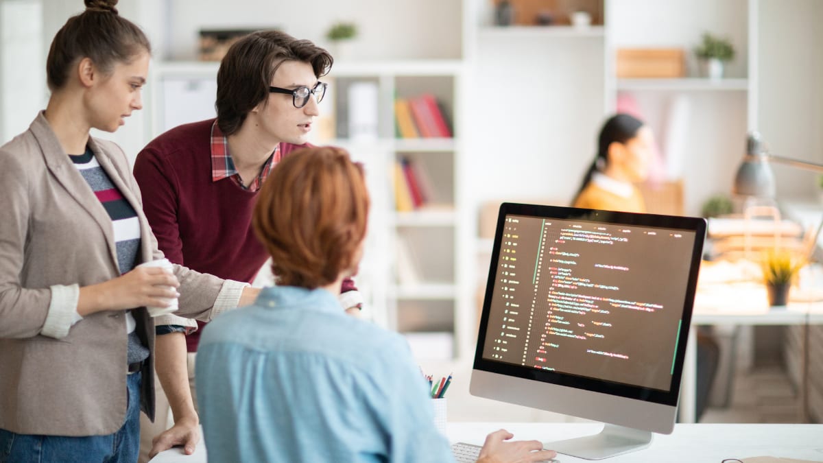 cybersecurity team meeting together at a desk